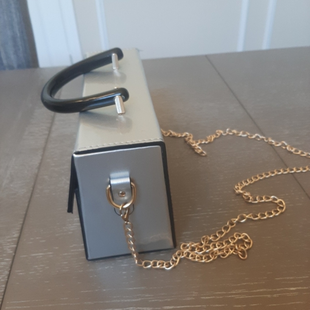 Chic Silver Clutch with Black Handles and Gold Chain